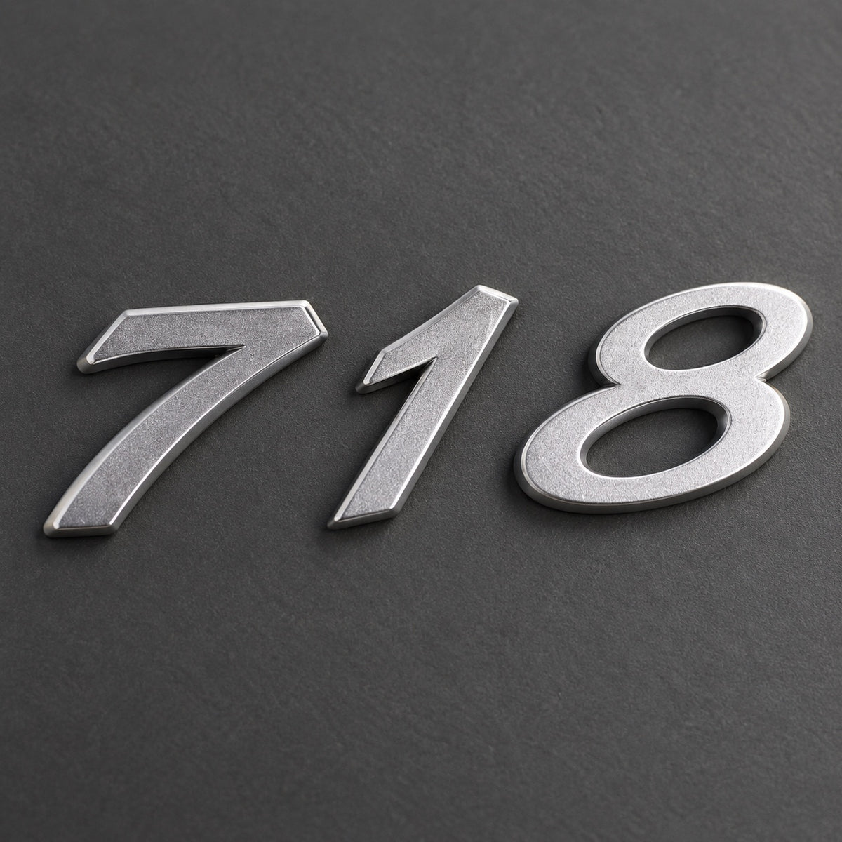 Silver-coloured aftermarket 718 badge set