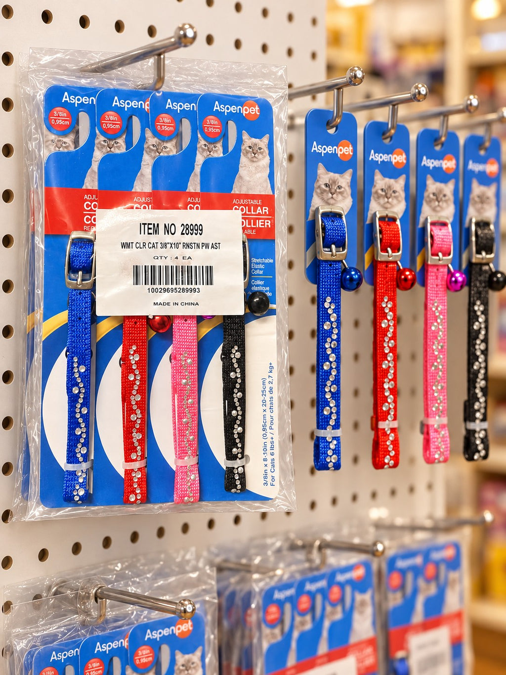 Aspen Pet collar packs on a pet-shop pegboard display (illustrative scene)