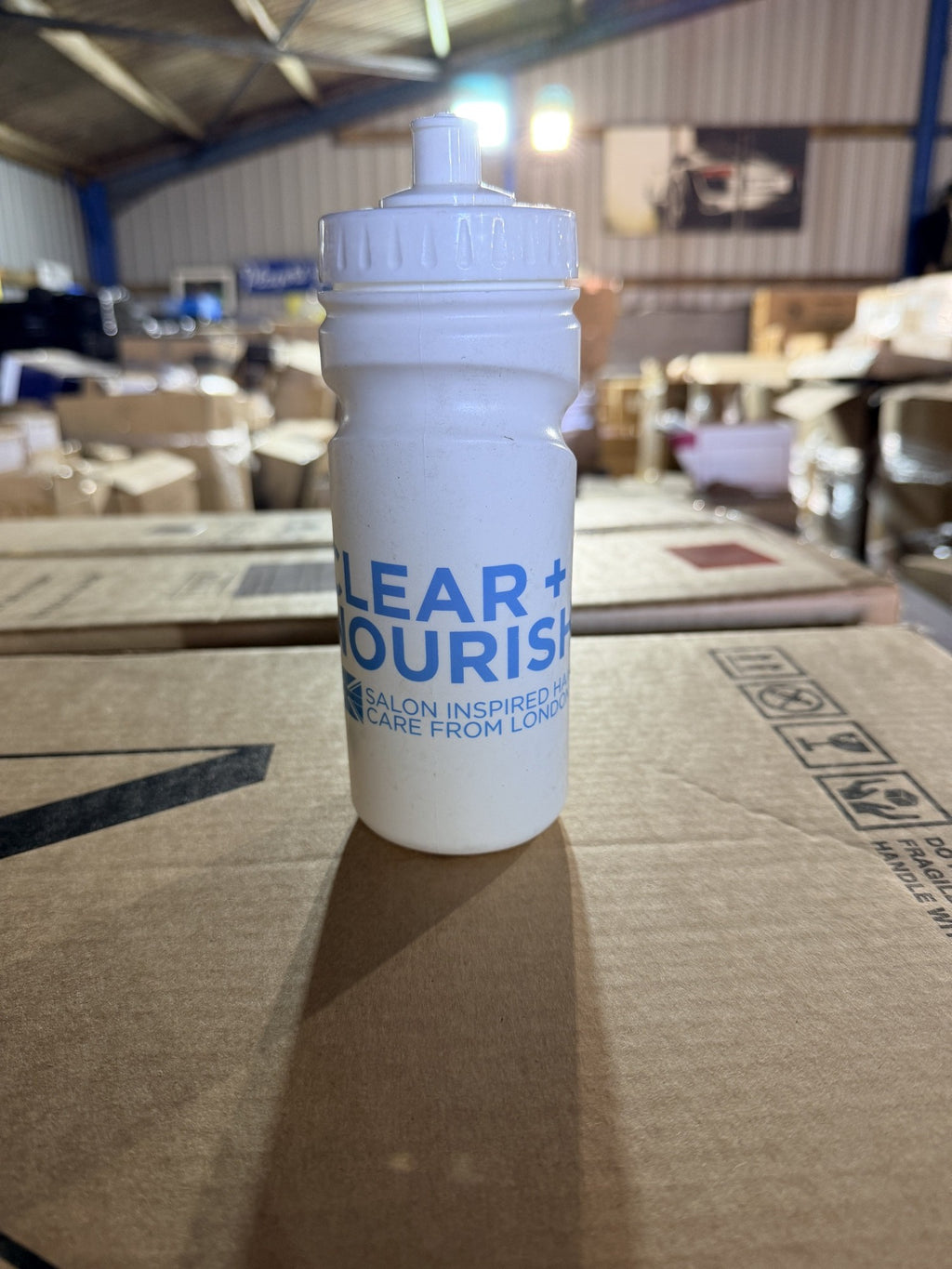 Real photo: front of the white 500ml sports bottle in our warehouse