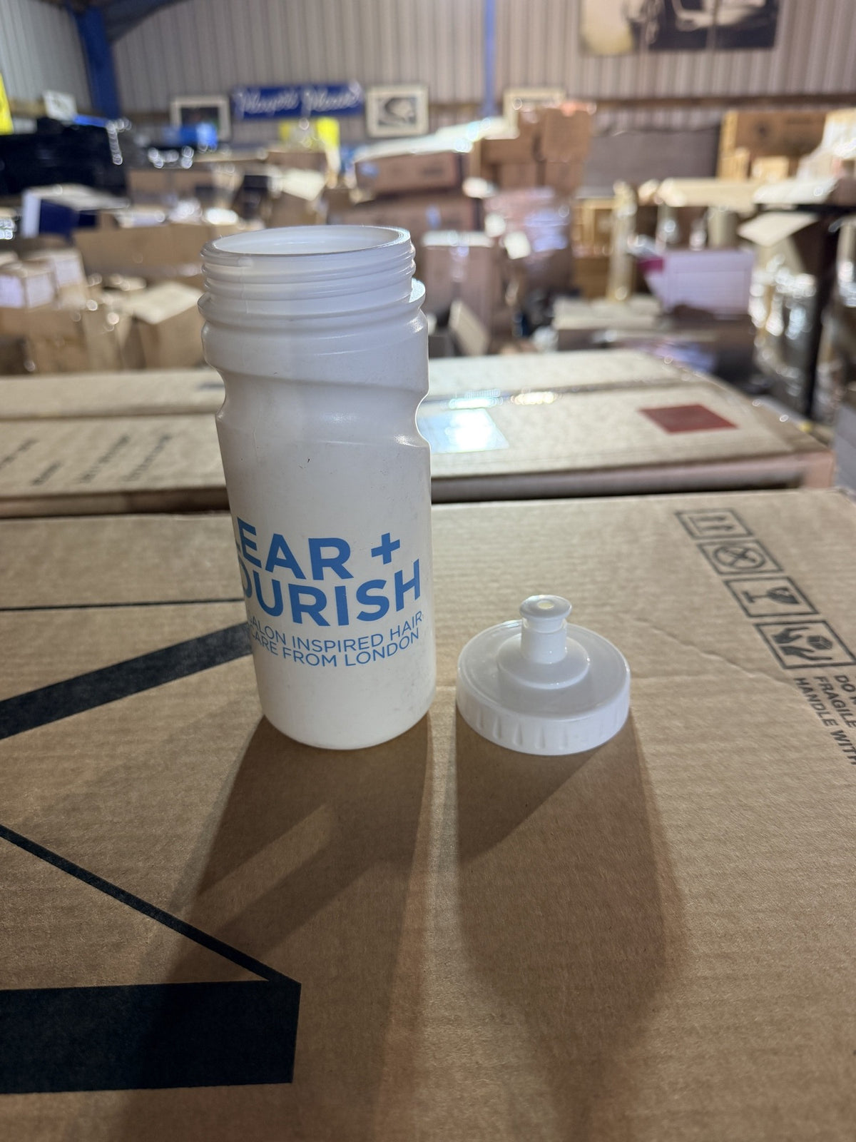 Real photo: bottle with the push-pull cap removed, wide screw neck
