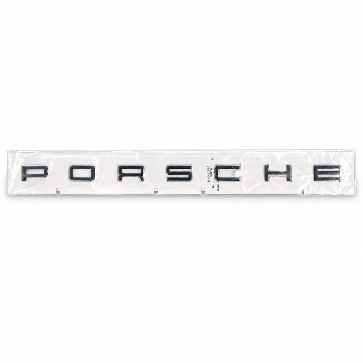 Black aftermarket Porsche seven-letter badge set in packaging