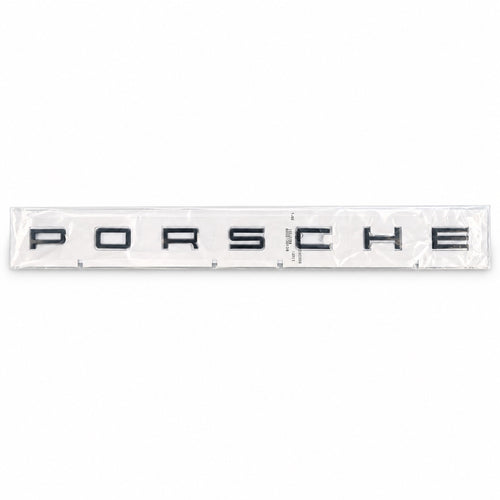 Black aftermarket Porsche seven-letter badge set in packaging