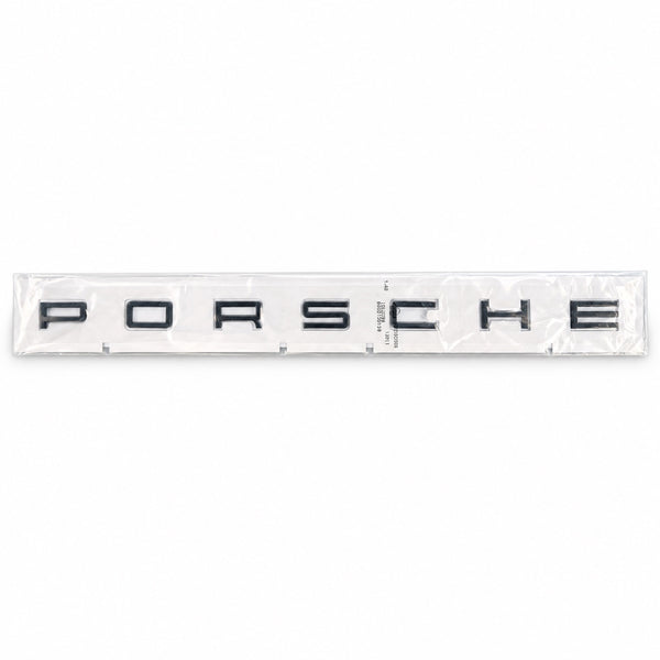 Black aftermarket Porsche seven-letter badge set in packaging