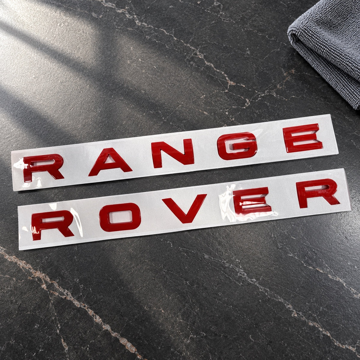Gloss red aftermarket Range Rover lettering set on fitting stencil