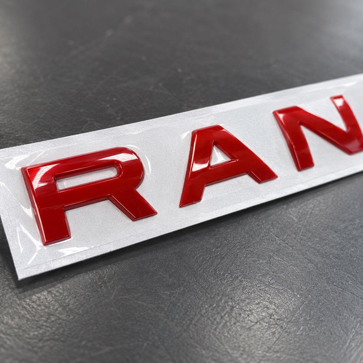 Gloss red aftermarket Range Rover lettering set on fitting stencil