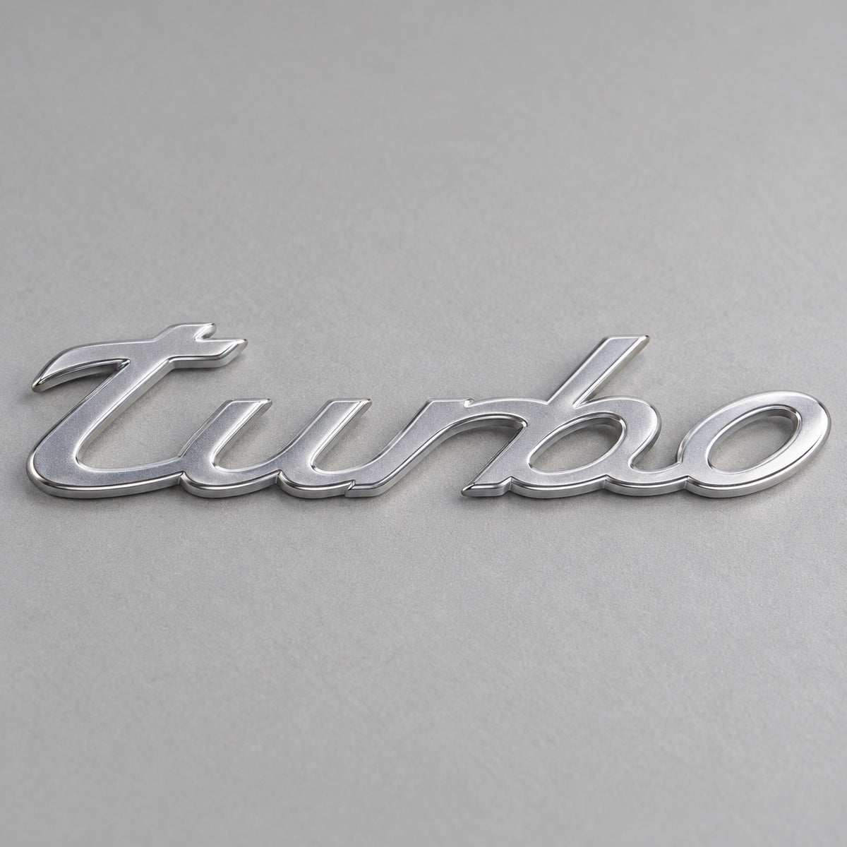 Silver-coloured aftermarket turbo script badge